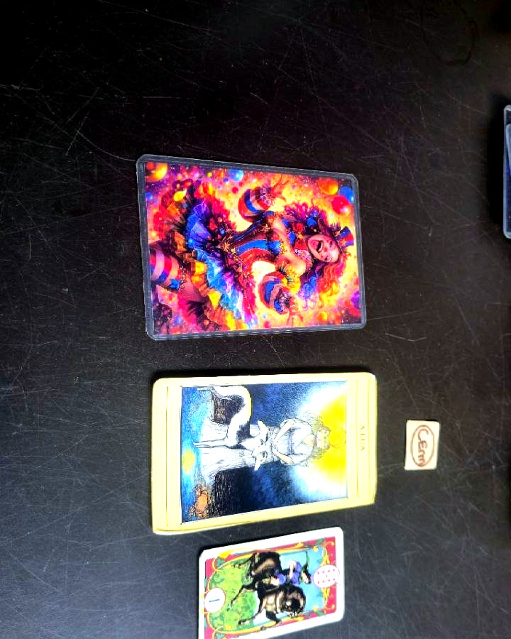 The three drawn cards up close on the dark table